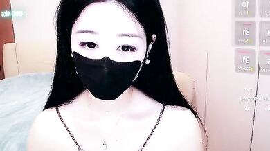 Watch petite Asian cam girl CN-xiaofei deepthroat a massive cock and get her face splattered with cum