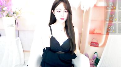 Petite Chinese MILF October_10 shows off her oiled-up body in a cosplay-filled office