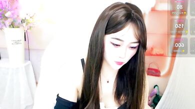 Petite Chinese MILF October_10 shows off her oiled-up body in a cosplay-filled office