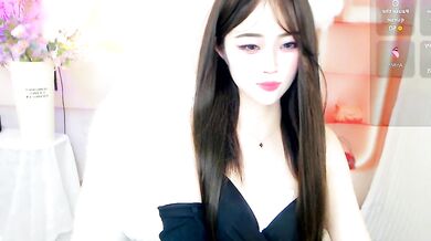 Petite Chinese MILF October_10 shows off her oiled-up body in a cosplay-filled office